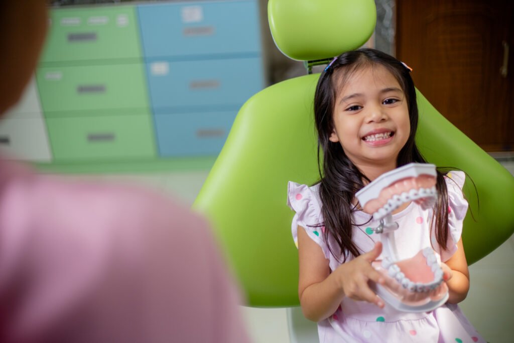 Smiling little girl on dental chair